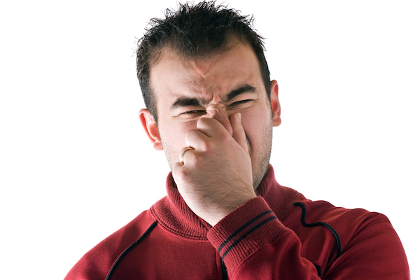 man holding his nose