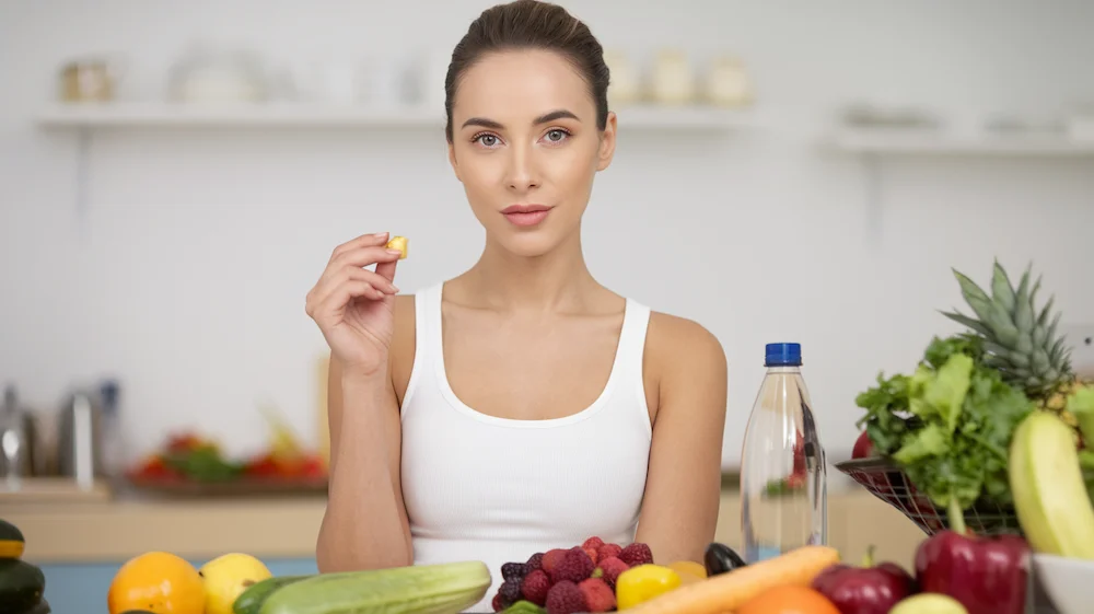 female enjoying fresh produce and water